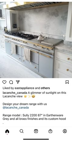 an instagramted photo of a kitchen with white cabinets and gold trim on the stove