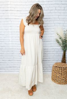 Get your boho-chic on with our Mel Dress! This playful maxi features a smocked top for a perfect fit, while the plaid print and ruffled hem add a touch of whimsy. Perfect for any occasion, this dress will have you feeling stylish and comfortable. 100% Polyester Cotton Maxi Smocked Dress With Ruffles, Cotton Maxi Dress For Picnic, Plaid Midi Dress With Smocked Bodice, Casual Plaid Maxi Dress For Summer, Beige Maxi Dress With Ruffle Hem For Beach, Casual Gingham Maxi Dress For Summer, Casual Plaid Maxi Dress For Picnics, Spring Vacation Gingham Maxi Dress, Summer Plaid Maxi Dress