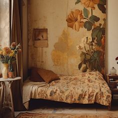 a bed sitting in a bedroom next to a wall with flowers on it's side