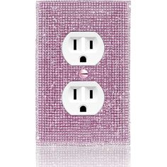 a pink and white light switch cover with two lightshades in the middle, on a