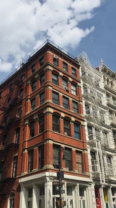 a tall red brick building sitting on the corner of a street