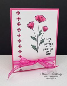 a card with pink ribbon and flowers on it