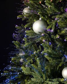 a close up of a christmas tree with ornaments on it