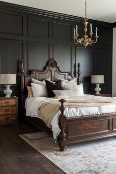 a bedroom with black paneled walls and white bedding, chandelier above the bed