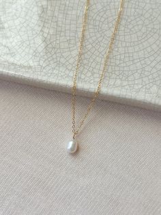 This single freshwater pearl necklace is classic and timeless. The minimal and versatile style looks lovely with both casual and dressy outfits. This is a piece of jewelry that will always be in style! * 14K Gold Filled or 925 Sterling Silver Chain and spring clasp * Choose your length * Natural 9mm Freshwater Pearl (pearl shape: oval to teardrop) * 14/20 gf or 925 stamp for authenticity * Made with all hypoallergenic materials 🤍 See more Pearl Jewelry here!: https://etsy.me/3zMbXyh GET TO KNOW MAGBEE JEWELRY! ✨ 🤍 All MagBee pieces are safe for sensitive skin and made with hypoallergenic Gold Filled or 925 Sterling Silver. 🤍 I only use real/natural gemstones and Pearls. 🤍 Most items are made to order just for you and have a 2-4 day processing time. 💌 All domestic orders over $35 ship Classic Oval Pendant Necklace For Wedding, Dainty Teardrop Pearl Necklace For Everyday, Delicate Oval Pearl Charm Jewelry, Classic Oval Pearl Necklace For Wedding, Delicate Oval Pearl Drop Jewelry, Minimalist Teardrop Pearl Necklace, Oval Pearl White Necklace For Wedding, Pearl White Oval Necklace For Wedding, Everyday Minimalist Teardrop Pearl Necklace