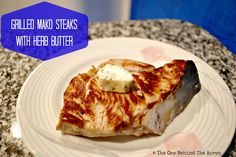 grilled mako steaks with herb butter on a plate