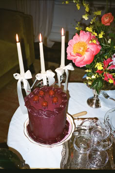 there is a cake with candles on the table