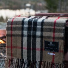 a plaid blanket sitting on top of a fire pit