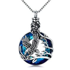 Eagle Urn Necklace for Ashes ♥ Honoring your loved one with an eagle urn necklace is a way to communicate much about what was important to them while keeping their memory close to your heart.♥ Eagle Cremation Necklace ♥ Eagle Cremation Necklace Size : 0.85*1.33 inces,weight ：7.5 g.Matching 20 inches long chain.♥ STERLING SILVER CRYSTAL NECKLACE ♥ s925 sterling silver eagle urn necklace with 14k white gold plated, Nickle-free, Lead-free and hypoallergenic. Protect and safe for sensitive skin.Make the metal surface smooth and durable, not easy to fade, rust, tarnish, turn skin green.🎁Best Choice🎁 The best heart tree of life crystal urn necklace for women, girls, fathers, mothers, grandmothers, grandfathers, sisters, sons, wives, daughters, husbands, brothers, friends or other family member Silver Crystal Necklace, Cremation Necklaces, Urn Necklace, Silver Eagle, Urn Necklaces, Heart Tree, Blue Circle, Silver Eagles, An Eagle