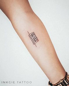 a small tattoo on the arm of a woman's left arm, which has an abstract geometric design