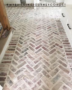 an image of a brick floor that is being used as a bathroom vanity area in a house