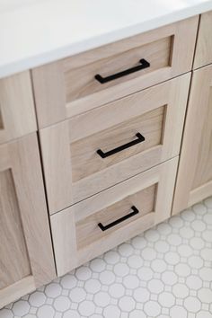 a close up of a bathroom vanity with drawers