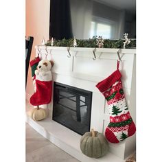 a fireplace with stockings and decorations hanging from the mantle