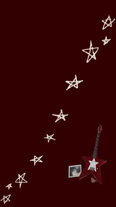 a red guitar with white stars on it and a photo hanging from the neckline