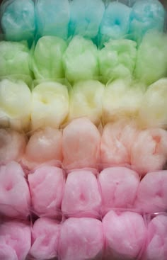 several different colored balls of cotton sitting next to each other