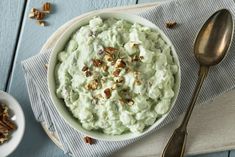 a bowl of mashed potatoes with walnuts on the side