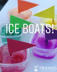 three plastic containers filled with different colored ice boats and one has an arrow sticking out of it