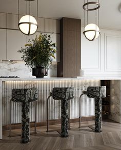 two black and white marble bar stools in front of a counter with flowers on it