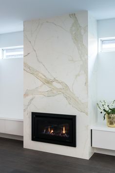 a fireplace in a room with white walls