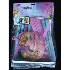 the tangled party favors are packaged in pink and have princess hair clips on top of them