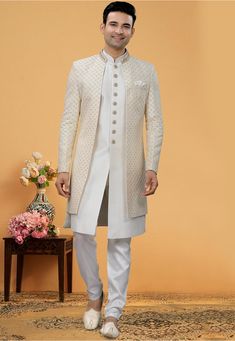 Art Silk Sherwani in Off White This Readymade attire is Enhanced with Buttons, Resham, Sequins and Beads Work. Crafted in Chinese Collar Neck and Full Sleeve Available with an Art Silk Pant in Off White and an Art Silk Long Jacket in Off White Do note: Bottom Style and Footwear shown in the image is for presentation purposes only. Half to one inch may vary in measurement. (Slight variation in actual color vs. image is possible) Wedding Kurta For Men, Mens Sherwani, Sherwani For Men, Men's Ethnic Wear, Court Dresses, Chinese Collar, Beads Work, Embroidered Art, Floral Pajamas