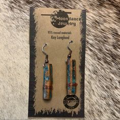 the earrings are made out of metal and wood