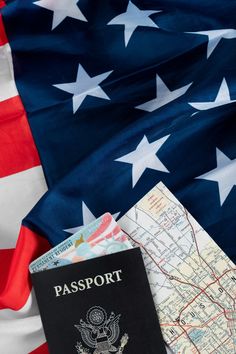 an american flag and passport laying on top of each other next to the us flag