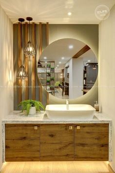 a bathroom with a sink, mirror and wooden cabinet in front of the counter top