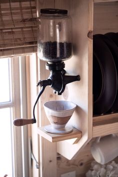 a kitchen shelf with plates and cups on it