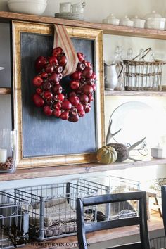 an image of a wreath hanging on the wall in front of a shelf with other items