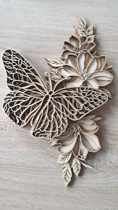 a wooden cutout of a butterfly on a table