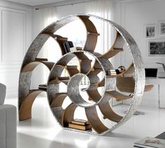 a living room filled with furniture and a large circular book shelf in the middle of it