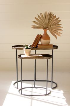 two tables with books and vases on them