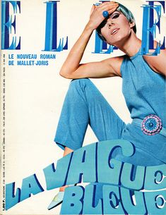 a woman sitting on the cover of a magazine wearing blue clothing and holding her head in her hands