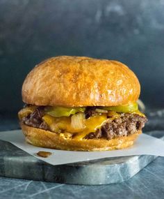 a cheeseburger on a bun with the words wisconsin butter burgers above it