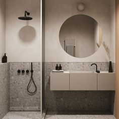 a bathroom with a sink, mirror and shower head in the wall next to it