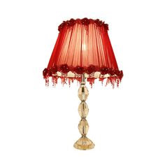 a table lamp with a red shade on it