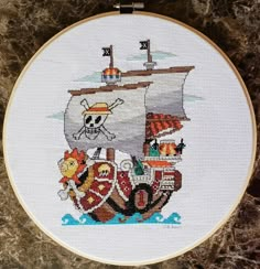 a cross stitch pattern with an image of a pirate ship on it's side