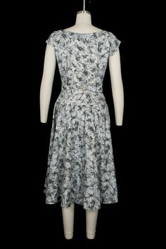 "vintage gray floral dress short sleeve w. notched neckline attached pleated belt w. buckle back accent tailored nipped in waist incredibly flattering garment no material tag - feels like midweight cotton blend circa late 1950s condition: good - some light wearwear does not distract from overall impact, presents beautifully freshly laundered & ready to wear would best fit a size: extra small / small compare flat measurements to ensure proper fit: shoulder: free bust: 18\" waist: 13.5\" hips: Vintage Fitted Gray Dresses, Fitted Vintage Gray Dress, Floral Dress Short, Black Velvet Gown, Far Rockaway, Grey Floral Dress, Notched Neckline, Floral Dresses Short, Dress Short Sleeve