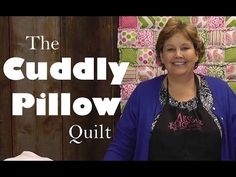 a woman standing in front of a pile of quilts with the words, the buddy pillow quilt