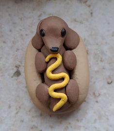 a toy dog with a banana in it's mouth