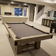 a pool table in the middle of a living room