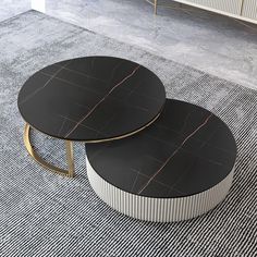 two black and white tables sitting on top of a carpeted floor next to each other