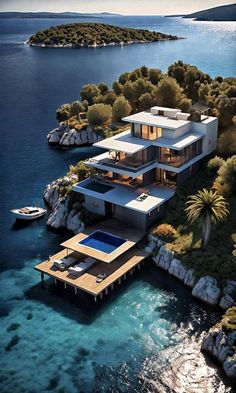 an aerial view of a house on the water