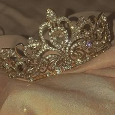 a gold tiara sitting on top of a bed