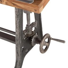 an old metal and wood work bench with gears on the front, wheels on the back