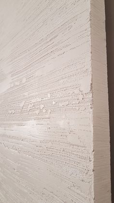 the corner of a wall with white paint on it