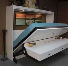 a bed that is in the middle of a room with a storage compartment underneath it