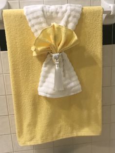 a yellow and white towel hanging on the wall