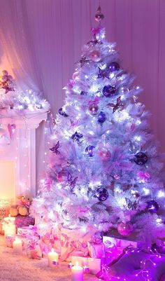 a white christmas tree with purple and pink lights